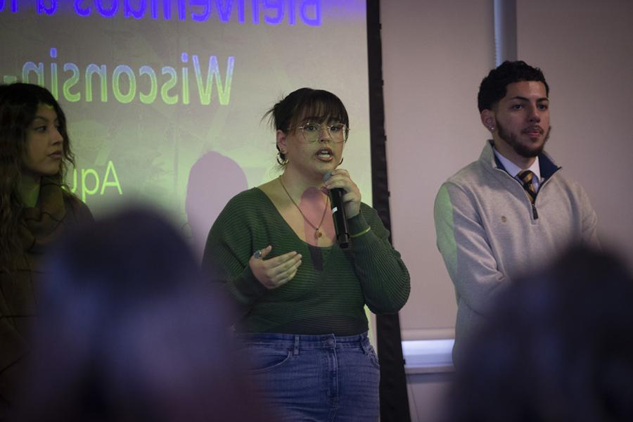 A student speaks in front of a crowd.