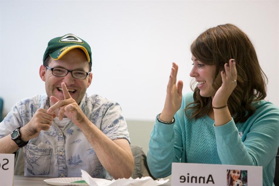 LIFE staff clapping their hands with a LIFE student smiling.